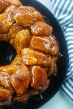 a bundt cake covered in caramel glaze on top of a black plate