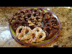 a plate full of donuts with sprinkles and chocolate frosting on them