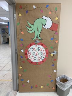 a door decorated with a happy birthday message and a santa hat on it's head