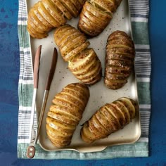 baked potatoes on a plate with a knife and fork