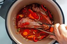 someone is stirring some food in a pot