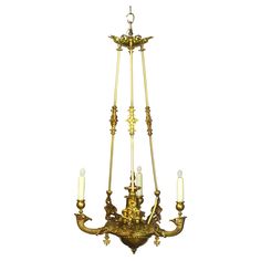 an antique chandelier with five candles hanging from the bottom and four lights on each side