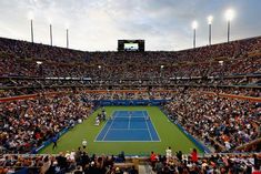 a tennis match is being played in an empty stadium