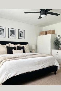 a bedroom with a bed, dresser and two pictures on the wall above it's headboard