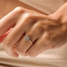 a woman's hand with a diamond ring on it