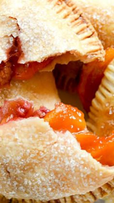 a close up of a pie with some fruit on the top and one slice missing