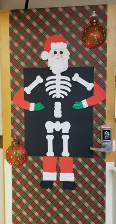 a paper cut out of a skeleton and santa clause