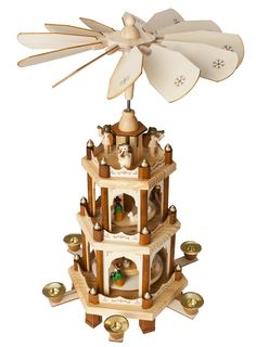 a wooden tower with bells on top and a wind spiner attached to the top