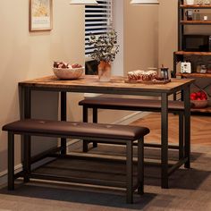 a kitchen table with two benches and a potted plant on the counter next to it