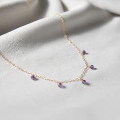 "This hand made necklace features a stunning selection of Amethyst dewdrops, perfectly arranged on a dainty but durable chain in your preferred finish. This necklace makes a wonderful gift for an Aquarius/Pisces or an Amethyst-lover in your family or friend circle. Chain Options: * Sterling Silver * Gold Filled * Rose Gold Filled Necklace Length Guide: * 14\"-15\" lays closely around neck * 16\" fits loosely around neck * 18\" lays on collarbone * 20\" lays just below collarbone * 22\" lays just Drop Necklace With Stones As Gift, Drop Necklace With Stones For Gift, Gift Drop Necklace With Stones, Purple Teardrop Pendant Necklace For Jewelry Making, Dainty Teardrop Pendant Necklace With Natural Stones, Purple Teardrop Necklaces For Jewelry Making, Purple Teardrop Necklace For Jewelry Making, Dainty Dangle Birthstone Necklaces, Purple Teardrop Pendant For Jewelry Making