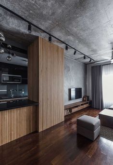 a living room filled with furniture and a flat screen tv on top of a hard wood floor