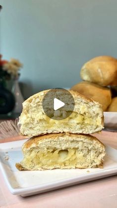 two pieces of bread sitting on top of a white plate next to some bagels