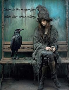 a woman sitting on a bench next to a crow