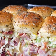 rolls with ham, cheese and other toppings on them