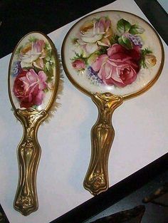 two golden spoons with flowers painted on them