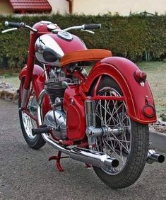 a red motorcycle is parked on the street