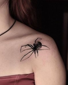 a woman with a spider tattoo on her shoulder