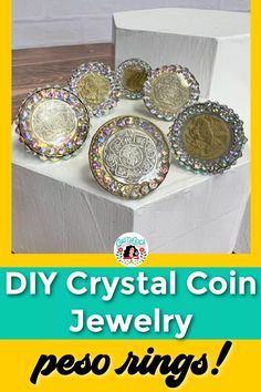 some gold and silver coins are sitting on top of a white box with the words diy crystal coin jewelry peso rings