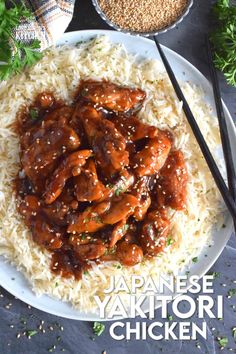 the plate has rice and meat on it with chopsticks in front of it