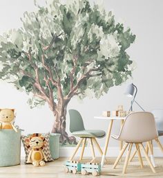 a child's room with a tree mural on the wall and toys in front