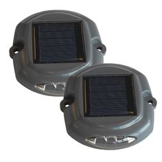 pair of solar powered outdoor lights on white background