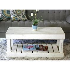 a white coffee table sitting on top of a rug