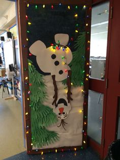 a door decorated with christmas lights and a polar bear