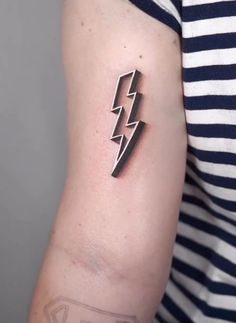 a woman's arm with a lightning tattoo on the left side of her arm