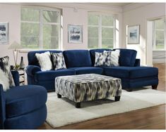 a living room with blue couches and pillows