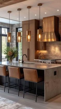 a large kitchen with an island and lots of lights hanging from it's ceiling