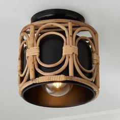 the light fixture is made out of wood and has an intricate design on it's side