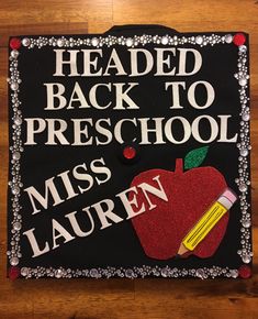 a decorated sign that says, headed back to preschool miss lauren on the front with an apple and pencil