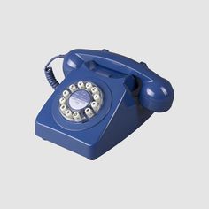 an old - fashioned blue phone is shown on a white background