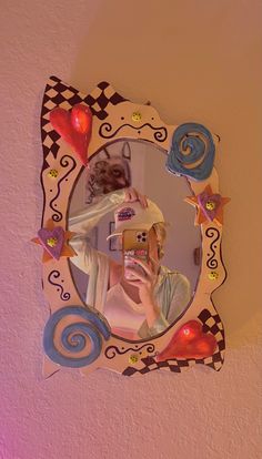 a woman taking a selfie in front of a mirror