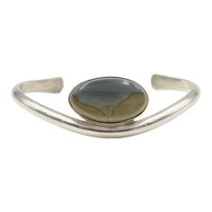 Vintage Native American sterling silver cuff bracelet featuring an oval agate. Marked on the back sterling.  Interior of the cuff measures 4.5" with an additional 1.25" gap for a total circumference of 5.75".  Sterling Silver is relatively malleable, thus this cuff is slightly adjustable. Width measures 2.34" straight across the widest part (from wrist bone to wrist bone). Bracelet face measures .72" tall (the face of the bracelet, north to south). Bracelet depth from top to the underside of wri Chanel Cuff Bracelet, Chanel Cuff, Bone Bracelet, Gemstone Cuff Bracelet, Bones Bracelet, Brass Cuff Bracelet, Metal Cuff Bracelet, Brass Cuff, Gold Bracelet Cuff