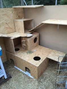 an outdoor cat house made out of plywood