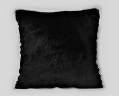 a black fur pillow on a white background