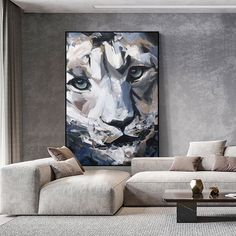 a living room filled with furniture and a large painting on the wall above it's couch