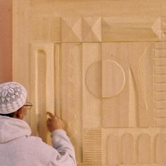 a person working on an art project with wood carving