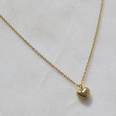 Dainty, classic, and minimalist gold stainless steel heart pendant necklace that will keep its color for a long time when handled with care, perfect for everyday wear and that is safe for your sensitive skin. 💎Free shipping on all orders💎Packaging that is ready to offer as a gift💎Customizable and adjustable chain length A dainty gold heart necklace, a perfect gift for a loved one Make someone's day or treat yourself with this stunning heart-shaped necklace. Symbolizing love and affection, its Luxury Minimalist Heart Necklace For Anniversary, Luxury Minimalist Yellow Gold Heart Necklace, Minimalist Stainless Steel Heart Charm Jewelry, Delicate Heart Pendant Necklace, Everyday Heart Pendant Charm Necklace With Delicate Chain, Dainty Heart Necklace For Everyday, Simple Heart Pendant Necklace For Everyday, Gold Minimalist Heart Necklace With Round Pendant, Dainty Heart Necklace Tarnish Resistant Everyday