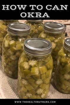 several jars filled with pickles sitting on top of a table