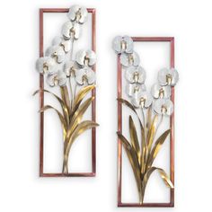 two metal wall art pieces with flowers in the middle and one on the other side