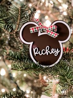 a mickey mouse ornament hanging from a christmas tree