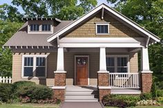 a small house with front porch and steps leading up to it