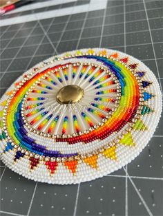 the beaded tray has a gold button on it