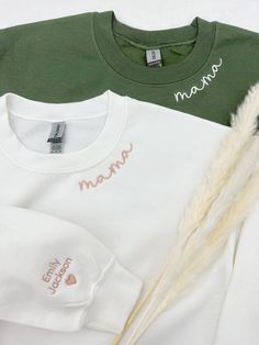 Embroidered Custom Neck Mama Sweatshirt With Kids Names on Sleeve, Gift For Mom, Personalized Children Name, Mothers day, Baby Shower Gift The product in the first picture is made with pink beige color thread on a white sweatshirt and cream white color thread on a military green sweatshirt. 💕WELCOME TO Love Stitches Co If you are looking for soft, comfy, first-rate sweatshirts, you're in the right place! Here at Love Stitches Co, we love what we do and strive to make your shopping experience ju Mother's Day Crew Neck Top With Embroidered Text, Mother's Day Embroidered Text Crew Neck Top, White Tops With Embroidered Graphics For Mother's Day, Embroidered White Tops For Mother's Day, White Embroidered Tops For Mother's Day, Custom Embroidered White Tops For Mother's Day, White Tops With Letter Embroidery For Mother's Day, Family Matching White Sweatshirt With Letter Embroidery, White Family Matching Sweatshirt With Letter Embroidery