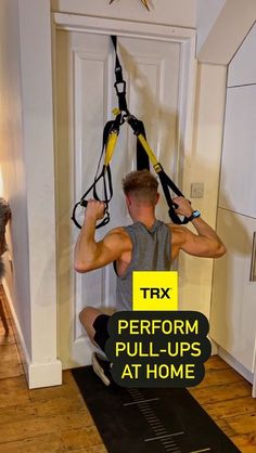 a man hanging from a rope in the middle of a room with text that reads trx perform pull - ups at home