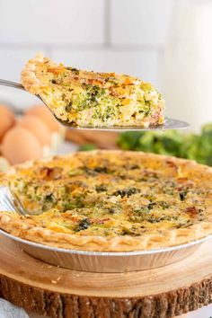 a quiche being lifted from a pie pan