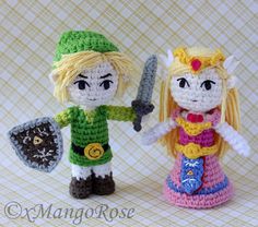 two crocheted figurines, one holding a knife and the other standing next to each other