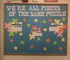 a bulletin board with puzzle pieces on it that says we're all pieces of the same puzzle